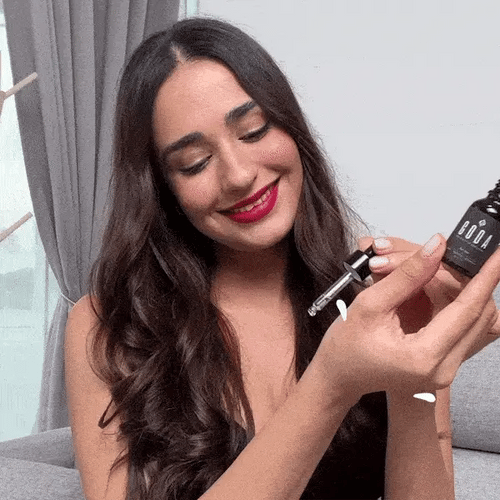 Indian woman applying Mohini Itr to her wrist